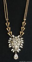 Full necklace showing chain, cone links, and rhinestone pendant
