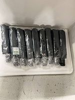 Ten folded umbrellas in plastic sleeves