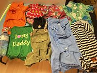 Group shot of all nine dog garments laid out on table