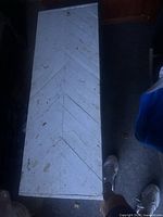 top view showing chevron plank pattern and distressed white paint