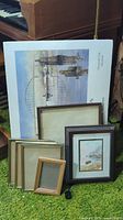 All items grouped: signed print, framed sailboat print, six assorted empty frames