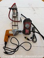 All three items laid out together: drill, foot pump, 12V compressor