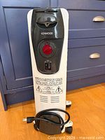 Front view of Kenwood oil-filled heater showing control panel, cord and casters