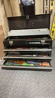 Front view of Husky toolbox open, showing drawers with tools