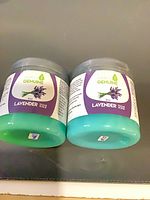 Front view of two sealed Simply Genuine lavender sugar scrub jars