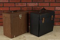 Front view of both record cases, showing overall design and size comparison
