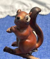 Front view of ceramic chipmunk figurine on branch