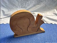 Front view of assembled wooden snail puzzle on base