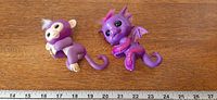 Both Fingerlings toys side by side with ruler for scale