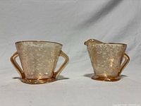 Front view of creamer and sugar bowl showing overall form and pattern