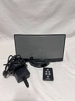 Front view of Bose SoundDock Classic docking speaker with remote and power adapter