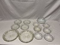 Group shot of all 14 clear pressed glass pieces