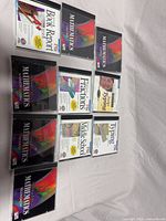 Nine jewel-cased CD-ROMs laid out, showing front inserts