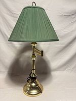 Full view of lamp showing green shade and brass base