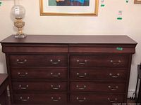 Front view of 10-drawer dark brown dresser showing hardware and two-column layout