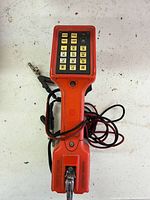 Front view showing keypad, housing color and attached test lead