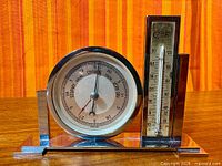 Front view showing complete chrome weather station on wooden surface