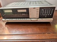 Front view of JVC JR-S301 receiver showing controls, meters and equalizer sliders
