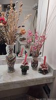 Group view showing tall vase, small vase, candle holders with candles, faux floral stems, potted succulent
