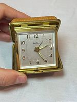 Clock in open position showing dial, case interior