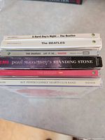 Stacked view of six CD spines identifying titles