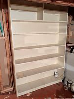 Front view of full bookshelf showing shelves and cubbies