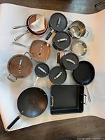 Top-down view of entire 14-piece cookware set laid out