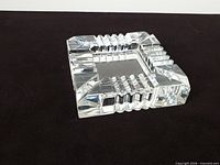 Top view of square lead crystal ashtray showing ridged rests and central basin