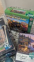 Three puzzle boxes: Wrebbit Harry Potter 3D, MasterPieces Panoramic, Buffalo Games Canoe Lake
