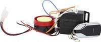 Alarm components laid out: siren, control module, wiring, remote