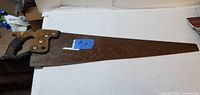 Full view of hand saw on table