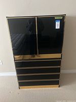 Front view of black and gold lacquer dresser, doors closed
