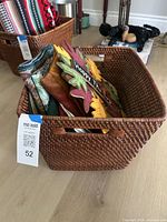 Basket filled with assorted linens and wreath visible