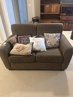 Front view of loveseat with all throw pillows displayed
