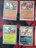 Four sleeved cards: Scorbunny, Pyroar, Genesect, Krookodile