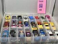 Top view of storage case showing first tray of assorted cars and Mario Kart figures