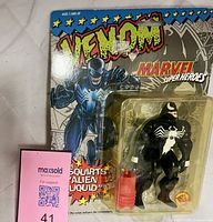 Full view of sealed Venom figure on card with accessory