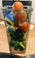 Vase filled with large multicoloured glass marbles