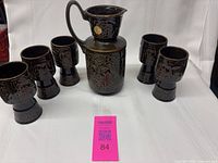 Pitcher and five goblets arranged together