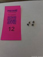 Lot overview showing both earrings next to lot card