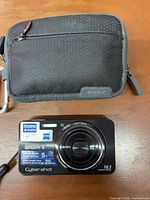 Front view of Sony DSC-W570 camera with case