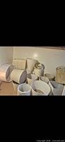 Group of mixed white and beige lampshades stacked together