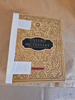 Front cover showing ornate design and tape repair