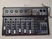 Full top view of 8-channel mixer showing inputs, outputs and controls