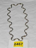Full view of necklace laid flat showing entire design and clasp