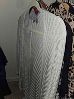 silver metallic knit open cardigan on hanger