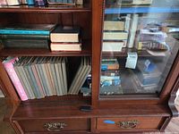 Bookshelf section showing assorted books and reference set