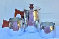 Three-piece tea set showing pot, creamer and sugar bowl together