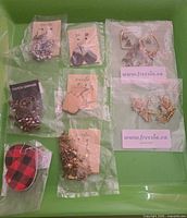 Group shot of all eight pairs in packaging on green background