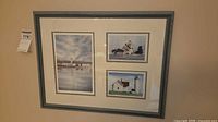Full view of framed print showing three lighthouse scenes in blue-gray frame